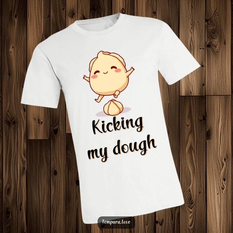 Funny t-shirt featuring a playful gyoza with tiny feet, energetically kicking a small ball of dough, highlighting culinary fun.